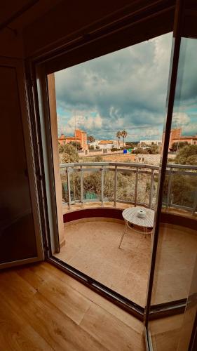 a balcony with a table and a view of a city at Red House Bed & breakfast in Llucmajor