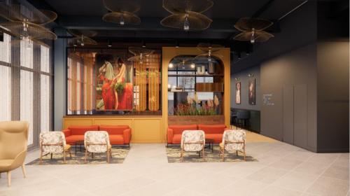 a waiting room with orange furniture and chairs at Hotel Indigo Coventry by IHG in Coventry