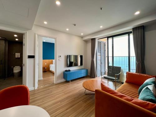 a living room with a couch and a television at Hillside Luxury Apartments by CASEPIA in Phu Quoc