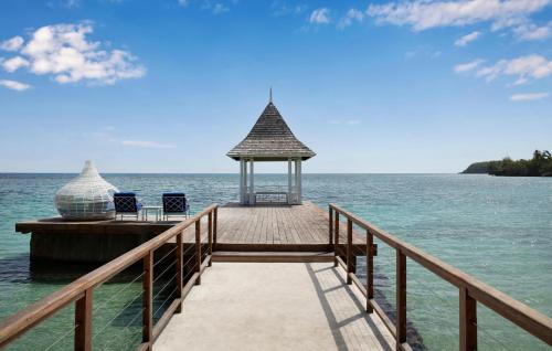 a pier with chairs and a gazebo on the water at Sandals Royal Plantation All Inclusive - Couples Only in Ocho Rios