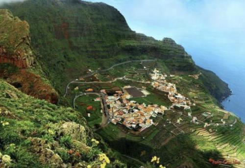 a village on the side of a mountain next to the ocean at VV Telemaco Green in Agulo