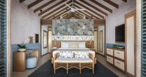 a bedroom with a bed and a tv in a room at Sandals Halcyon Beach All Inclusive - Couples Only in Vigie