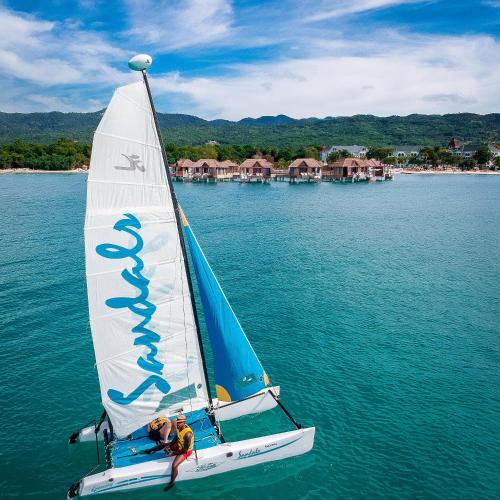 two people on a sail boat in the water at Sandals South Coast All Inclusive - Couples Only in Savanna-la-Mar