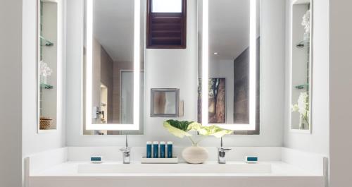 a bathroom with a sink with two mirrors at Sandals Royal Barbados All Inclusive - Couples Only in Christ Church
