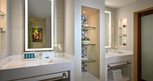 a bathroom with two sinks and a mirror at Sandals Royal Barbados All Inclusive - Couples Only in Christ Church