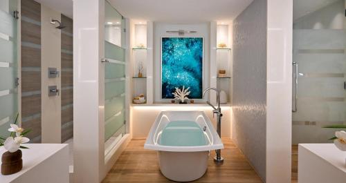 a bathroom with a bath tub and a window at Sandals Royal Barbados All Inclusive - Couples Only in Christ Church