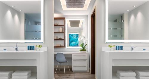 a bathroom with two sinks and a desk at Sandals Royal Barbados All Inclusive - Couples Only in Christ Church