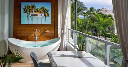 a bathroom with a tub and a view of the ocean at Sandals Royal Barbados All Inclusive - Couples Only in Christ Church