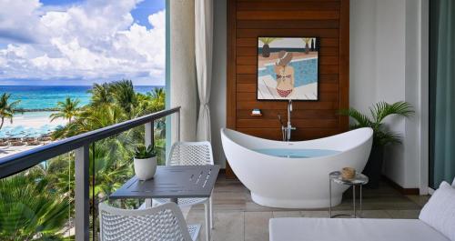 a bathroom with a tub and a view of the beach at Sandals Royal Barbados All Inclusive - Couples Only in Christ Church