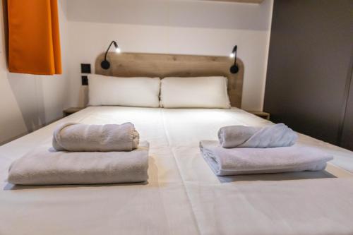 a bed with two pillows on top of it at HolaCamp Sant Salvador in Comarruga