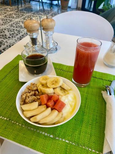 a plate of food with bananas and fruit on a table at Hôtel ESCALE - Aéroport Ivato in Ivato