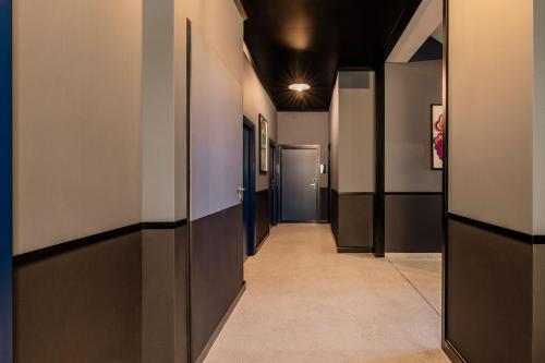 a hallway with a row of doors and a hallwayngthngthngthngth at Colette - LoftAffair Collection in Warsaw