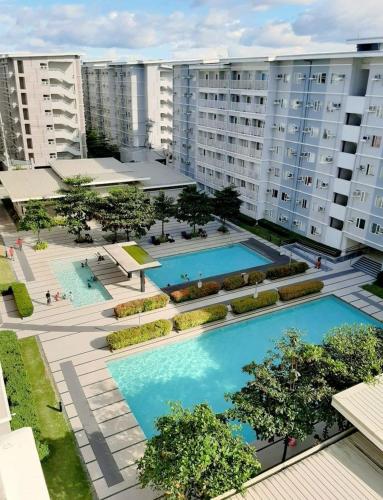 an overhead view of two swimming pools in a city at 1BR at Trees Residences with Balcony in Quezon City