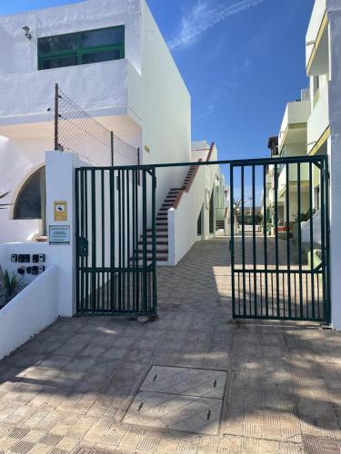 a gate in front of a house with stairs at FuerteSun Dunas beach in Parque Holandes