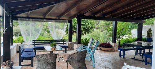 a patio with a table and chairs on a patio at Trullo la glycine in Ceglie Messapica