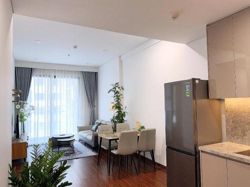 a kitchen and a living room with a table at Căn Hộ 2 Phòng Ngủ LUXURY-1816 in Gia Lâm Pho