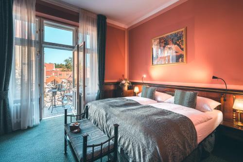 a bedroom with a large bed and a window at Hotel Hastal Prague Old Town in Prague