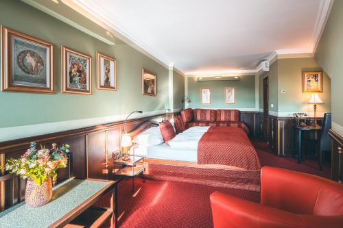 a hotel room with a bed and a couch at Hotel Hastal Prague Old Town in Prague