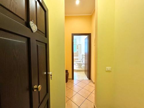 an open door to a hallway with a bathroom at Le Maioliche in Sferracavallo