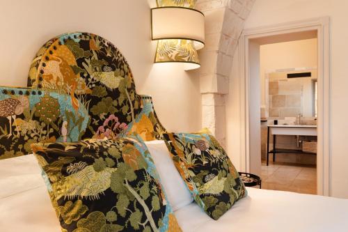 a bedroom with a bed with a pillow and a lamp at Masseria Santo Scalone in Ostuni