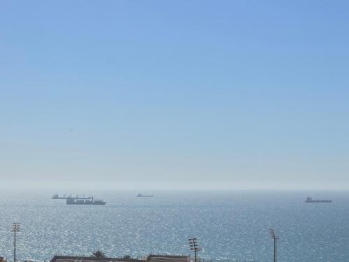 a view of the ocean with ships in the water at Four Seasons Apartment in Agadir