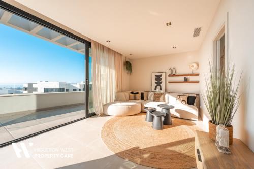 a large living room with a large window at Higueron West Property Collection - La CostaVale by HWPC in Fuengirola