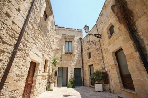 une rangée de bâtiments en pierre dans une ruelle dans l'établissement Chiesa Greca - SIT Rooms & Apartments, à Lecce