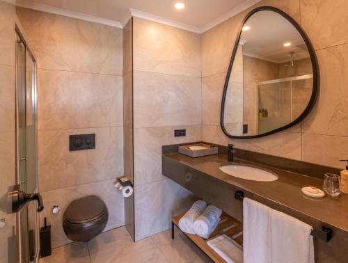 a bathroom with a sink and a mirror at Ethno Belek in Belek