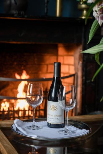 a bottle of wine and two wine glasses on a tray at Carrygerry Country House in Shannon