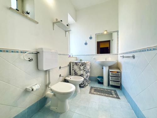 a bathroom with a toilet and a sink at Le Maioliche in Sferracavallo