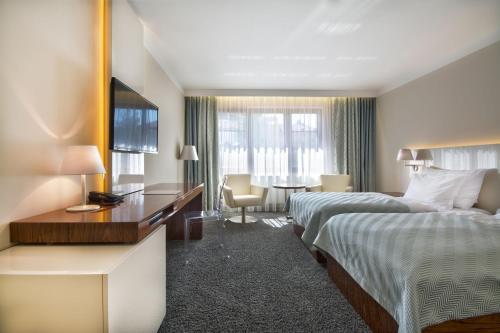 Postel nebo postele na pokoji v ubytování Prezident Luxury Spa & Wellness Hotel