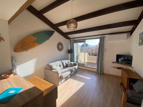 un salon avec un canapé et une table dans l'établissement Grand studio entre le golf et la plage à 800m, à Saint Cyprien Plage