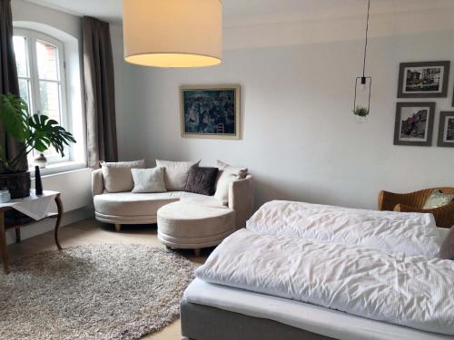 a living room with a bed and a couch at Villa Petzold in Spiegelau