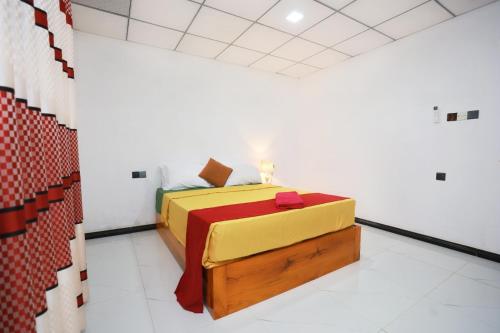 a bedroom with a bed in a white room at Alankulama Waana Resort in Anuradhapura