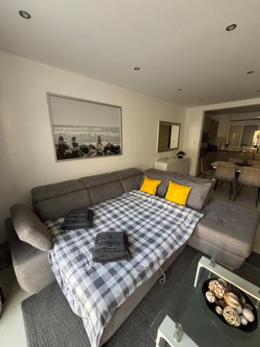 a living room with a couch and a table at Modern apartment direct access to Sliema beaches in Sliema