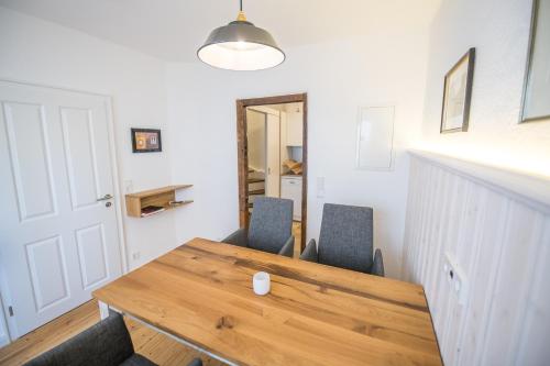 a dining room with a wooden table and two chairs at NEU - Historisches Ferienhaus nahe Mosel & Eifel - Zentrum Wittlich - 4 Personen in Wittlich
