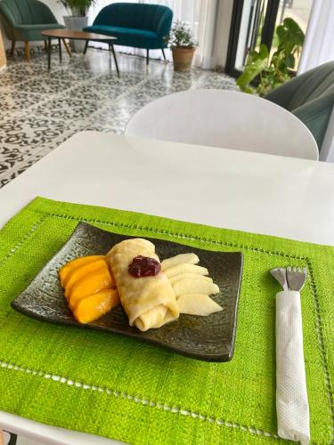 a plate of food on top of a table at Hôtel ESCALE - Aéroport Ivato in Ivato