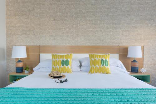 a bed with two lamps and a hat on it at Summercamp in Oak Bluffs