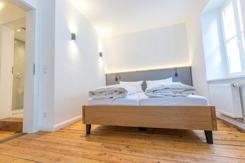 a bed with two pillows on it in a room at NEU - Historisches Ferienhaus nahe Mosel & Eifel - Zentrum Wittlich - 4 Personen in Wittlich