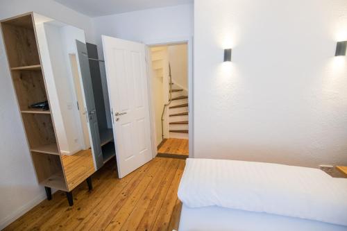 a small room with a bed and a closet at NEU - Historisches Ferienhaus nahe Mosel & Eifel - Zentrum Wittlich - 4 Personen in Wittlich
