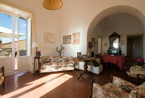 a living room with a couch and a table at Villa Pietralunga in the woods in Nicosia