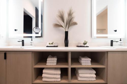 a bathroom with two sinks and two mirrors at Villas 2, 4 The Villas At Troon North in Scottsdale