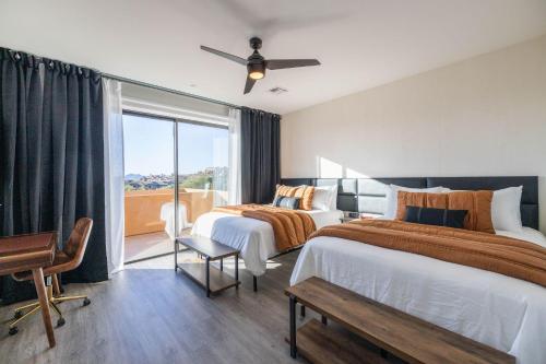 a hotel room with two beds and a balcony at Villas 2, 4 The Villas At Troon North in Scottsdale