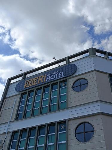 a building with a sign on the top of it at Keteri Boutique Hotel in Kangar