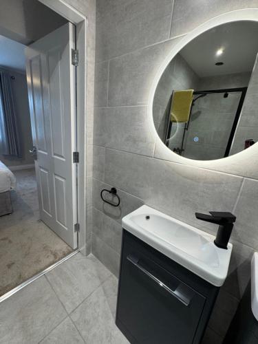 a bathroom with a sink and a mirror at No 20 Killarney Holiday Village in Killarney