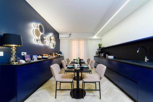 a dining room with a table and chairs at Shamika Luxury Rooms in Pontecagnano