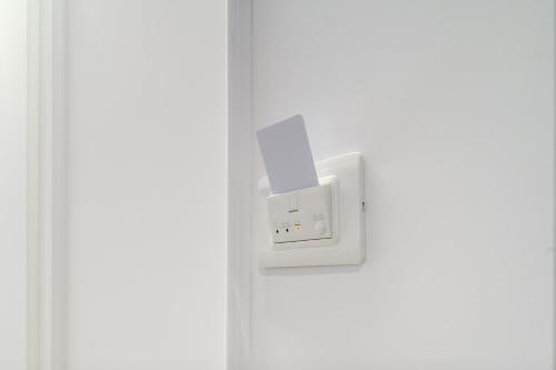 a white electrical outlet on a white door at Shamika Luxury Rooms in Pontecagnano