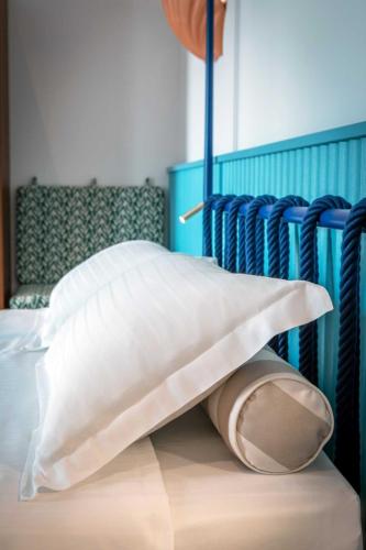 a bed with two white pillows on top of it at Murè Hotel Numana in Numana