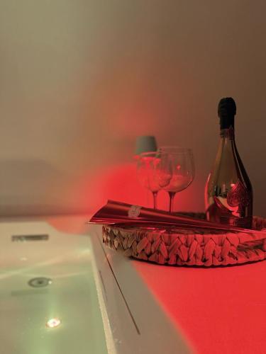 a table with two glasses and a bottle of wine at Angel Suite 2 in Selva di Fasano