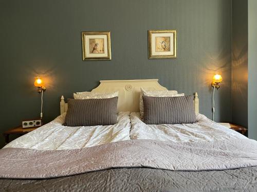 a bedroom with a large bed with two pillows at Alingsås Vandrarhem in Alingsås